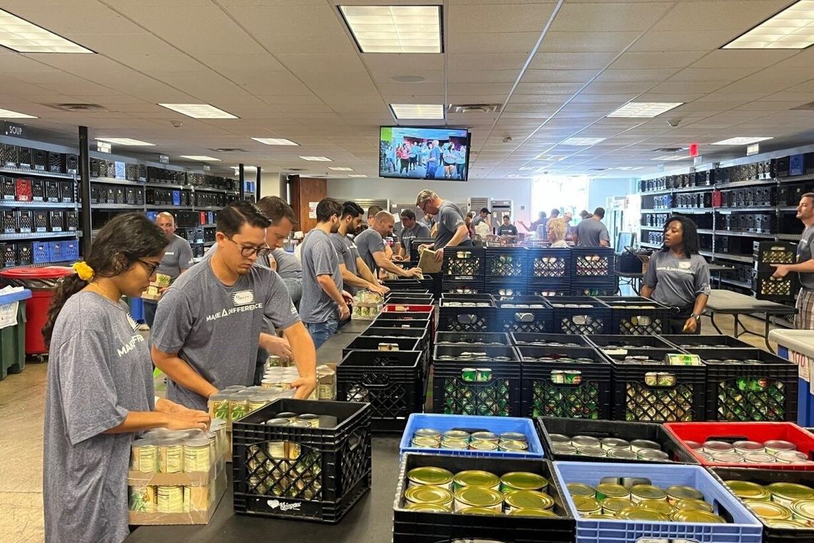 employees volunteering and packing crates
